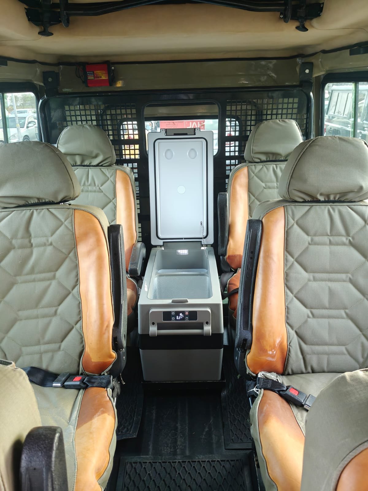 Inside our safari Land Cruiser — leather seats and cool box