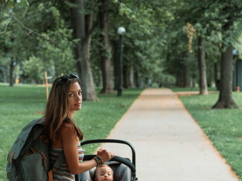 a mother with a toddler in a stroller