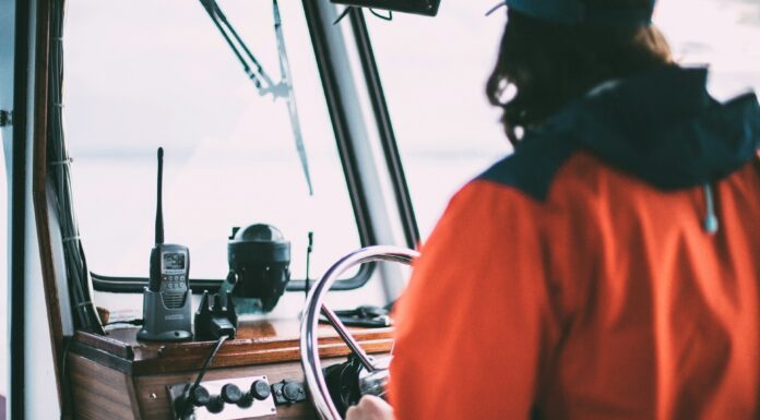 Best Travel Walkie Talkies a man traveling with on a boat with a walkie talkie