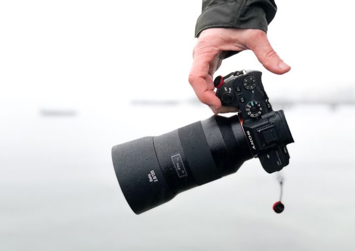 mirrorless camera a man holding a mirrorless camera