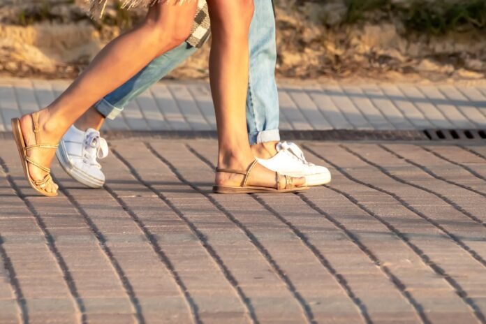 sandals a ma with a woman walking with sandals in Europe