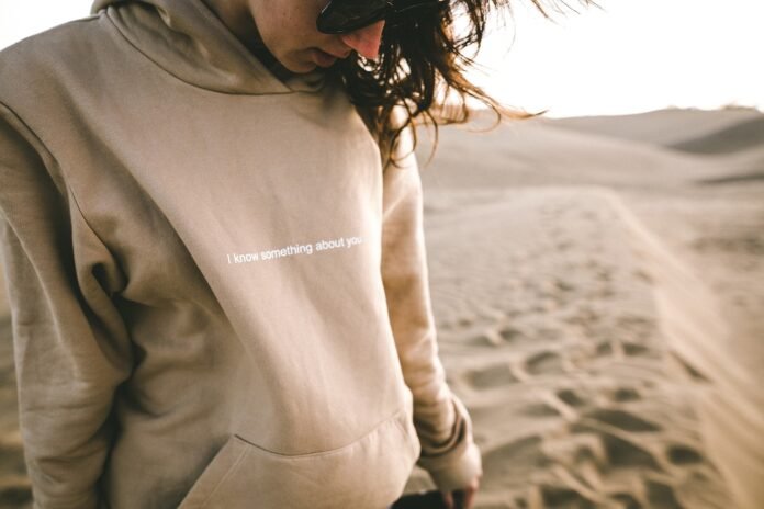a woman wearing a hoddie on safari