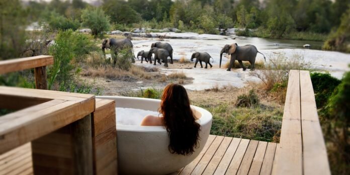 a woman having a bubble bath on an African safari for couples